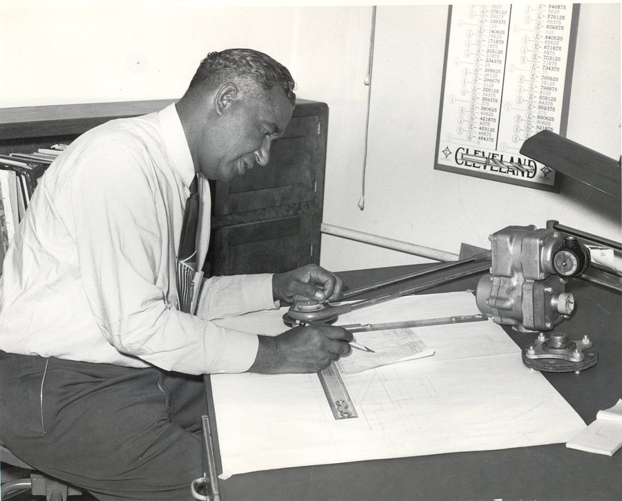 Frederick McKinley Jones working at a drafting table.
