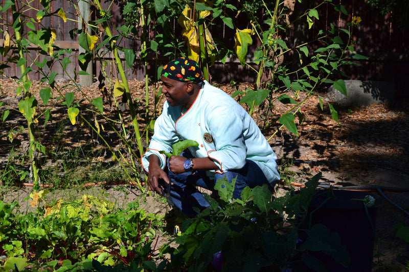 Chef Marvin Woods in the garden — farm-to-table coastal soul cooking philosophy